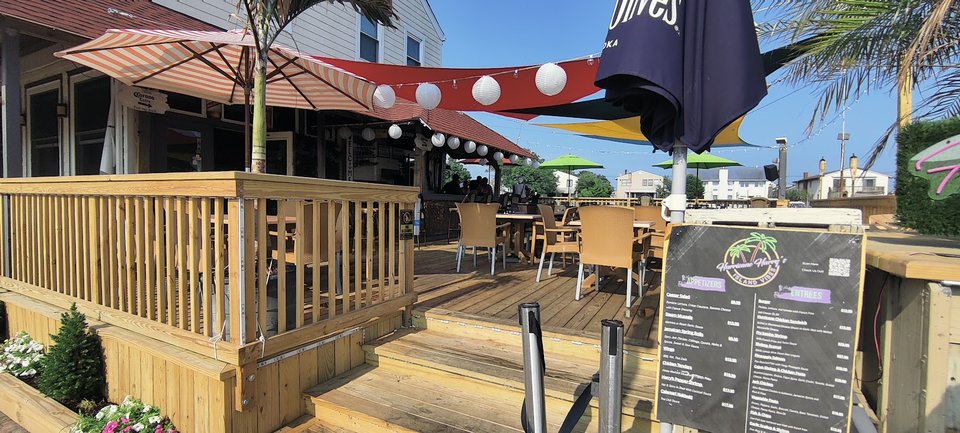 Waterfront bar with tables near the dock.